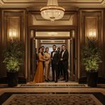 lucid-origin_elegant_group_entering_luxury_hotel_evening_16_9-0