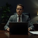 lucid-origin_executive_reviewing_documents_dark_office_cinematic_16_9-7